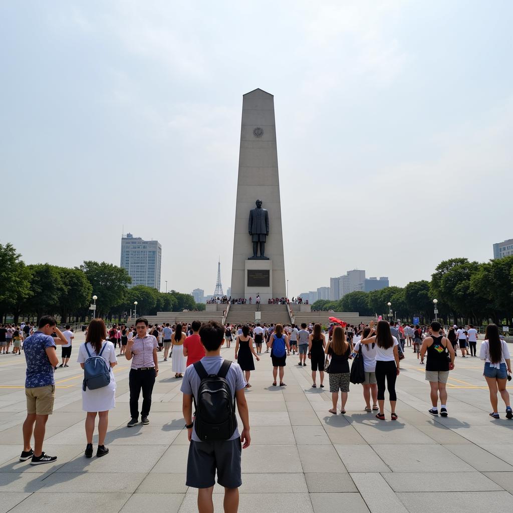 Du khách tham quan và chụp ảnh lưu niệm tại tượng đài Hồ Chí Minh ở Quảng trường Hồ Chí Minh Nghệ An.